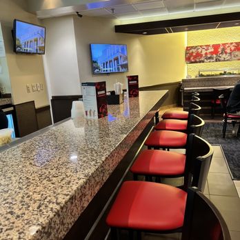 Benihana - a bar with red chairs and televisions - Sushi Bars Near Me - Lake Buena Vista, Florida Benihana - a bar with red chairs and televisions - Sushi Bars Near Me - Lake Buena Vista, Florida