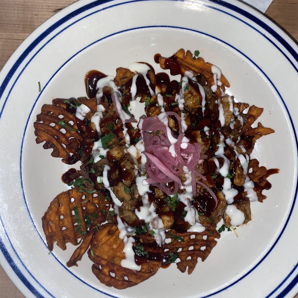 Jasper's - Pulled Pork over sweet potato waffle fries - New American Near Me - Nashville, Tennessee Jasper's - Pulled Pork over sweet potato waffle fries - New American Near Me - Nashville, Tennessee