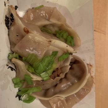Cai's Dim Sum Catering - Beef Dumplings!  My favorite! - Dumplings with a glossy surface and green onion garnish are served on a white paper tray, likely from an Asian cuisine restaurant. - Dim Sum Near Me - Brattleboro, Vermont