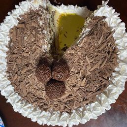 a chocolate cake with a slice taken out of it a chocolate cake with a slice taken out of it