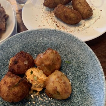 Cava Mezze - Olney - Hush puppies (front) and zucchini fritters (back) - Mediterranean Near Me - Olney, Maryland Cava Mezze - Olney - Hush puppies (front) and zucchini fritters (back) - Mediterranean Near Me - Olney, Maryland