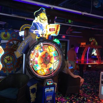 Bananas Mini Golf And Arcade - a woman playing a game - Mini Golf Near Me - Gulfport, Mississippi