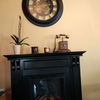 Hard Bean - a fireplace with a clock above it - Coffee & Tea Near Me - Merrick, New York Hard Bean - a fireplace with a clock above it - Coffee & Tea Near Me - Merrick, New York