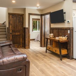 Alaska Backcountry Cottages - Pine Cottage- Walking in the front door, this is what you'll see, living area, stairs, downstairs bedroom