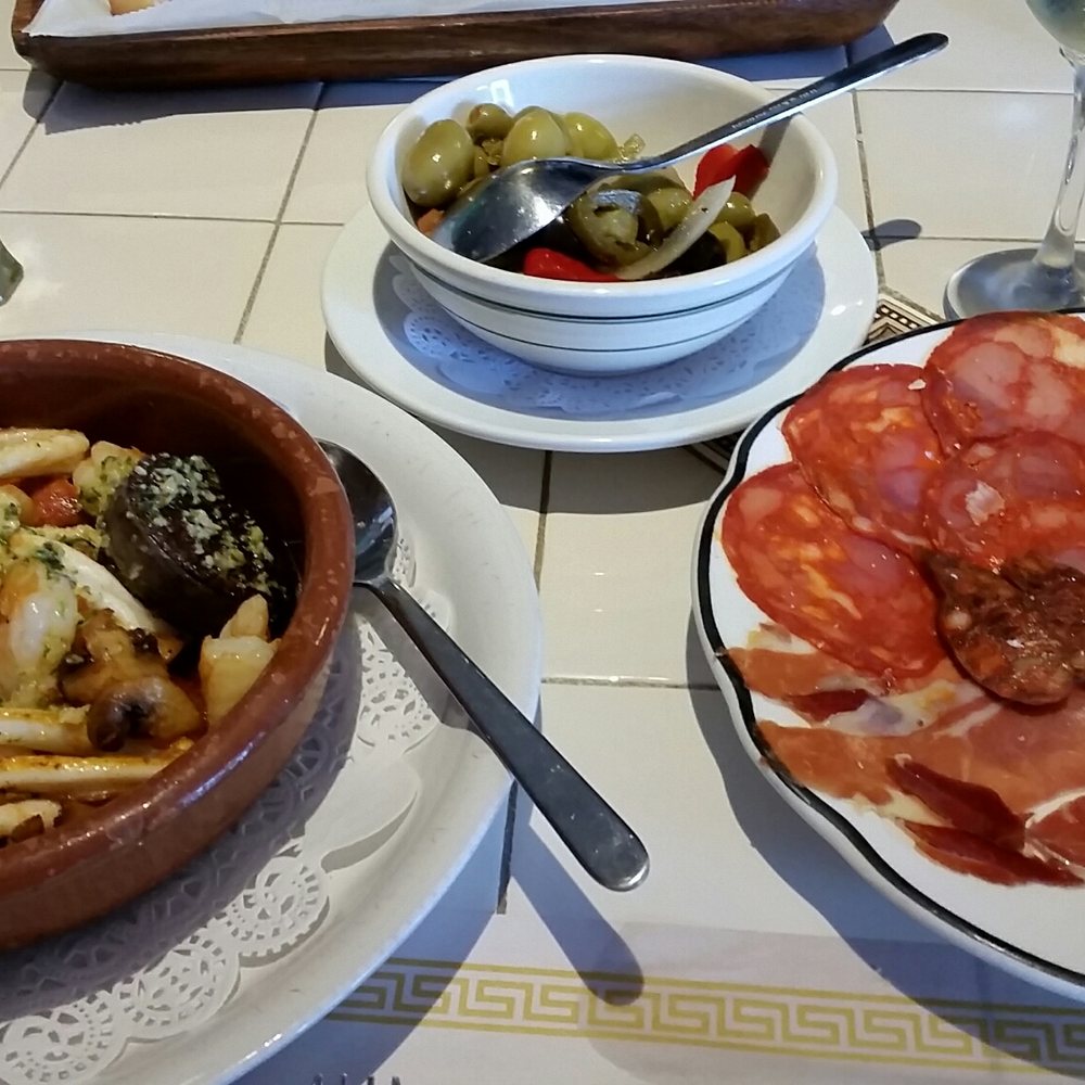 La Taberna De Ignacio - Hialeah - Tapas: seafood with chorizo and blood sausage; chorizo Cantimpalo, Serrano ham, Manchego cheese; seasoned olives. - Spanish Near Me - Hialeah, Florida La Taberna De Ignacio - Hialeah - Tapas: seafood with chorizo and blood sausage; chorizo Cantimpalo, Serrano ham, Manchego cheese; seasoned olives. - Spanish Near Me - Hialeah, Florida