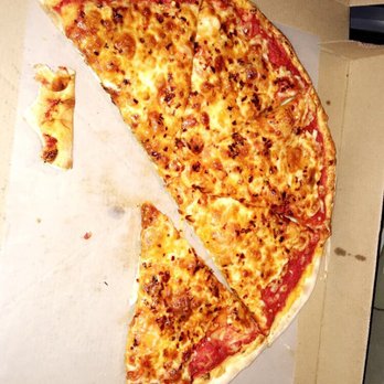 New Pizza Professor - a half eaten pizza in a box - Pizza Near Me - Flushing, New York