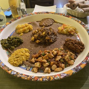 Cafe Abyssinia - Veggie platter with Dorowat and Tibs (chicken) - Ethiopian Near Me - New Orleans, Louisiana Cafe Abyssinia - Veggie platter with Dorowat and Tibs (chicken) - Ethiopian Near Me - New Orleans, Louisiana