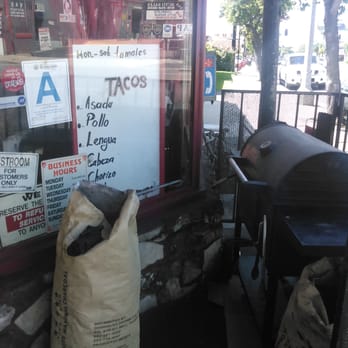 El Pollo Pio Pio - Pollos Pio Pio: BBQ w/ top down smoking away. Black piece of mesquite charcoal on brown paper bag. - Mexican Near Me - Tujunga, California El Pollo Pio Pio - Pollos Pio Pio: BBQ w/ top down smoking away. Black piece of mesquite charcoal on brown paper bag. - Mexican Near Me - Tujunga, California