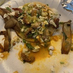 Taqueria Oaxaca - Tripe taco covered in grilled onions and red and green sauce.