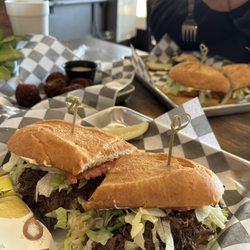 Hank's Sports Bar & Rumors Deli - Roast Beef Po-boy with Boudin balls in the background.