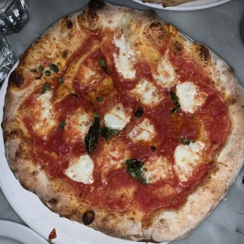 Pizzeria Libretto - a pizza on a white plate - Pizza Near Me - Toronto, Ontario