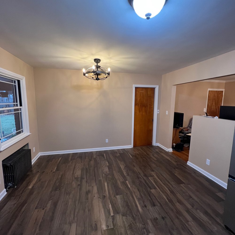 VB Renovations - empty living room with wood floors - General Contractors Near Me VB Renovations - empty living room with wood floors - General Contractors Near Me