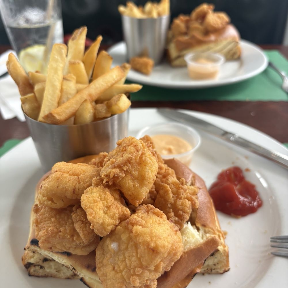 Scallops on a large grilled Brioche roll.  Serviced with perfectly cooked fries.