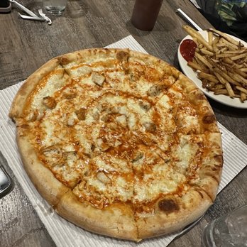 Savas - a pizza on a table with a plate of french fries - Pizza Near Me - Philadelphia, Pennsylvania Savas - a pizza on a table with a plate of french fries - Pizza Near Me - Philadelphia, Pennsylvania
