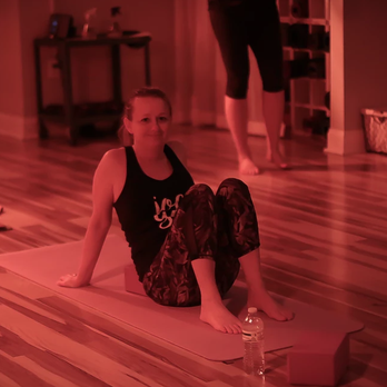 Victory Power Yoga - getting ready for class under the Infrared heat lamps! Photo: 2019 Erin Brown Photography. - Yoga Near Me - Clayton, North Carolina
