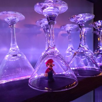 Arcade MTL - a row of wine glasses on a shelf - Bars Near Me - Montreal, Quebec Arcade MTL - a row of wine glasses on a shelf - Bars Near Me - Montreal, Quebec