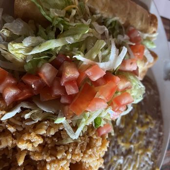 Headquarters Cafe - Flautas - A plate featuring fried chicken, shredded lettuce and tomato salad, and a burrito, served with a side of rice and beans. - American Near Me - Maricopa, Arizona
