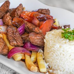 The Chicken Shack - Tender angus beef, sautéed onions and tomatoes, rice, French fries, lomo saltado