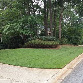 Lawn Rescues - a driveway with grass and trees in the background - Lawn Services Near Me Lawn Rescues - a driveway with grass and trees in the background - Lawn Services Near Me