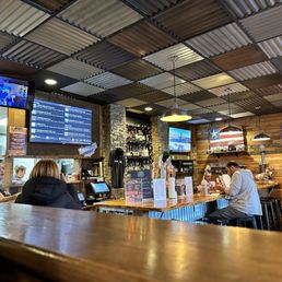 people sitting at the bar in a restaurant people sitting at the bar in a restaurant