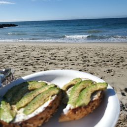 Enjoying my everything bagel with cream cheese, avocado and lemon pepper seasoning on the beach. Enjoying my everything bagel with cream cheese, avocado and lemon pepper seasoning on the beach.
