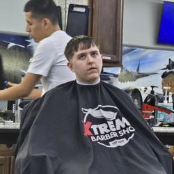 Xtreme Barber Shop - Getting hos hair cut