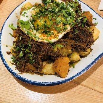 Austin Taco Project - Tots with cheese curds, barbacoa and a fried egg on top. - Tapas/Small Plates Near Me - Austin, Texas