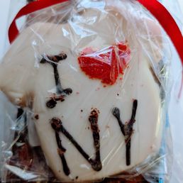 I 3 NY Cookies - A cookie decorated with white icing and the word "YAY" written in chocolate, wrapped in clear plastic with a red ribbon.