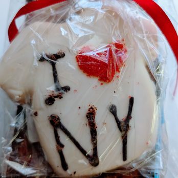Zabar's - I 3 NY Cookies - A cookie decorated with white icing and the word "YAY" written in chocolate, wrapped in clear plastic with a red ribbon. - Bakeries Near Me - New York, New York