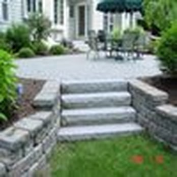 Tompkins Corporation - a view of a patio with steps leading up to the house - Landscaping Near Me - North Andover, Massachusetts