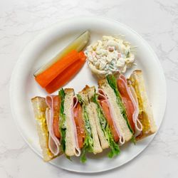 Champ's Deli Restaurant - The Deluxe Club with Turkey, Ham, and Bacon on 3 layers of bread!