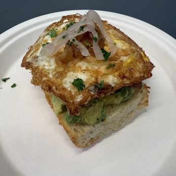 Dandelion Cafe - 1/2 Avocado Toast + Over Hard Egg - Cafes Near Me - Houston, Texas Dandelion Cafe - 1/2 Avocado Toast + Over Hard Egg - Cafes Near Me - Houston, Texas