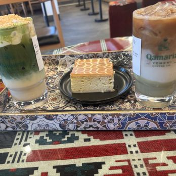 Qamaria Yemeni Coffee - Iced banana crumble matcha latte with shot of espresso , iced pistachio latte with oatmilk & caramel milk cake - Coffee & Tea Near Me - Riverside, California Qamaria Yemeni Coffee - Iced banana crumble matcha latte with shot of espresso , iced pistachio latte with oatmilk & caramel milk cake - Coffee & Tea Near Me - Riverside, California