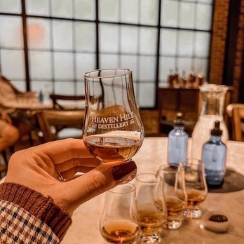 Heaven Hill Distilleries - a person holding a glass of wine - Distilleries Near Me - Bardstown, Kentucky Heaven Hill Distilleries - a person holding a glass of wine - Distilleries Near Me - Bardstown, Kentucky