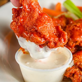Betsy Ross Diner - a hand dipping buffalo wings into a bowl of ranched ranch dressing - Diners Near Me - Jefferson, New Jersey Betsy Ross Diner - a hand dipping buffalo wings into a bowl of ranched ranch dressing - Diners Near Me - Jefferson, New Jersey