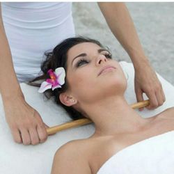 Christina's Healing Hands Massage Therapy - Neck traction using warm Bamboo-Fusion rods.