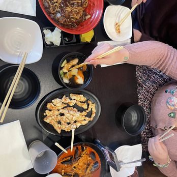JoongHwaRu - a woman eating a meal with chopsticks - Korean Near Me - Los Angeles, California