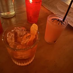 a glass of drink with a slice of lemon