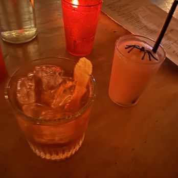 Black Crescent - a glass of drink with a slice of lemon - Cocktail Bars Near Me - New York, New York