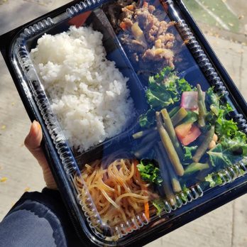 Joanne's Deli - a person holding a tray of food - Delis Near Me - Toronto, Ontario