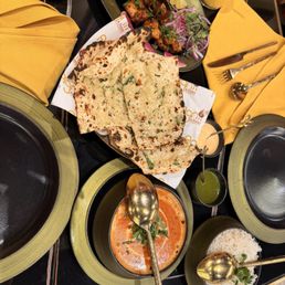 from up to down: zesty chicken tikka, garlic naan, butter chicken, basmati rice from up to down: zesty chicken tikka, garlic naan, butter chicken, basmati rice