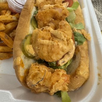 Across the Coast Seafood - A metal piece cooked into shrimp batter of my Po Boy Sandwich. - Wraps Near Me - Roswell, Georgia Across the Coast Seafood - A metal piece cooked into shrimp batter of my Po Boy Sandwich. - Wraps Near Me - Roswell, Georgia