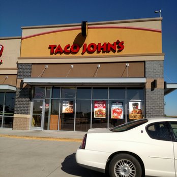 Taco John's - a white car parked in front of a taco john's restaurant - Fast Food Near Me - Grimes, Iowa