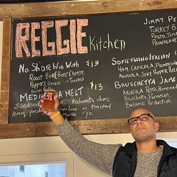 East Regiment Beer Company - a man holding a beer - Brewpubs Near Me - Salem, Massachusetts