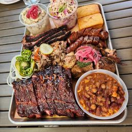 a platter of ribs and sides