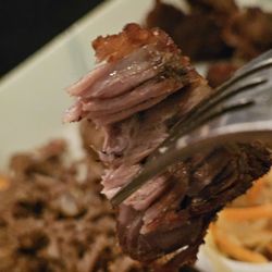 Gianni's Restaurant - A fork holding a piece of the fried pork.