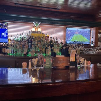 Masters Restaurant - a bar with a lot of bottles of alcohol - American Near Me - Madison Heights, Michigan