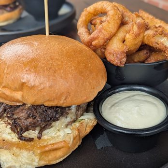 Jack Jones Bar - Farmer's Burger with onion rings and side of horseradish cream. - Irish Pub Near Me - Astoria, New York Jack Jones Bar - Farmer's Burger with onion rings and side of horseradish cream. - Irish Pub Near Me - Astoria, New York