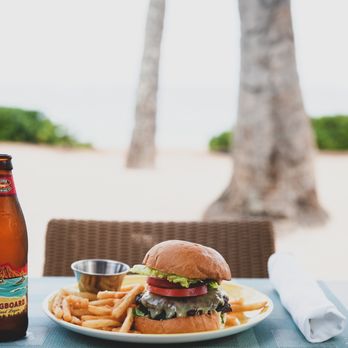 Seaside Grill - a burger and fries on a plate with a bottle of beer - Seafood Near Me - Honolulu, Hawaii Seaside Grill - a burger and fries on a plate with a bottle of beer - Seafood Near Me - Honolulu, Hawaii