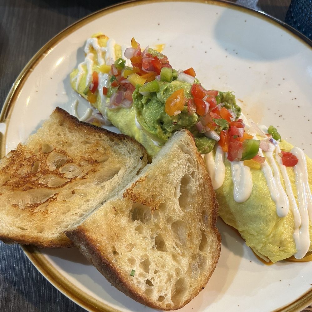 Carne Asada Omelet with a side sourdough bread Carne Asada Omelet with a side sourdough bread